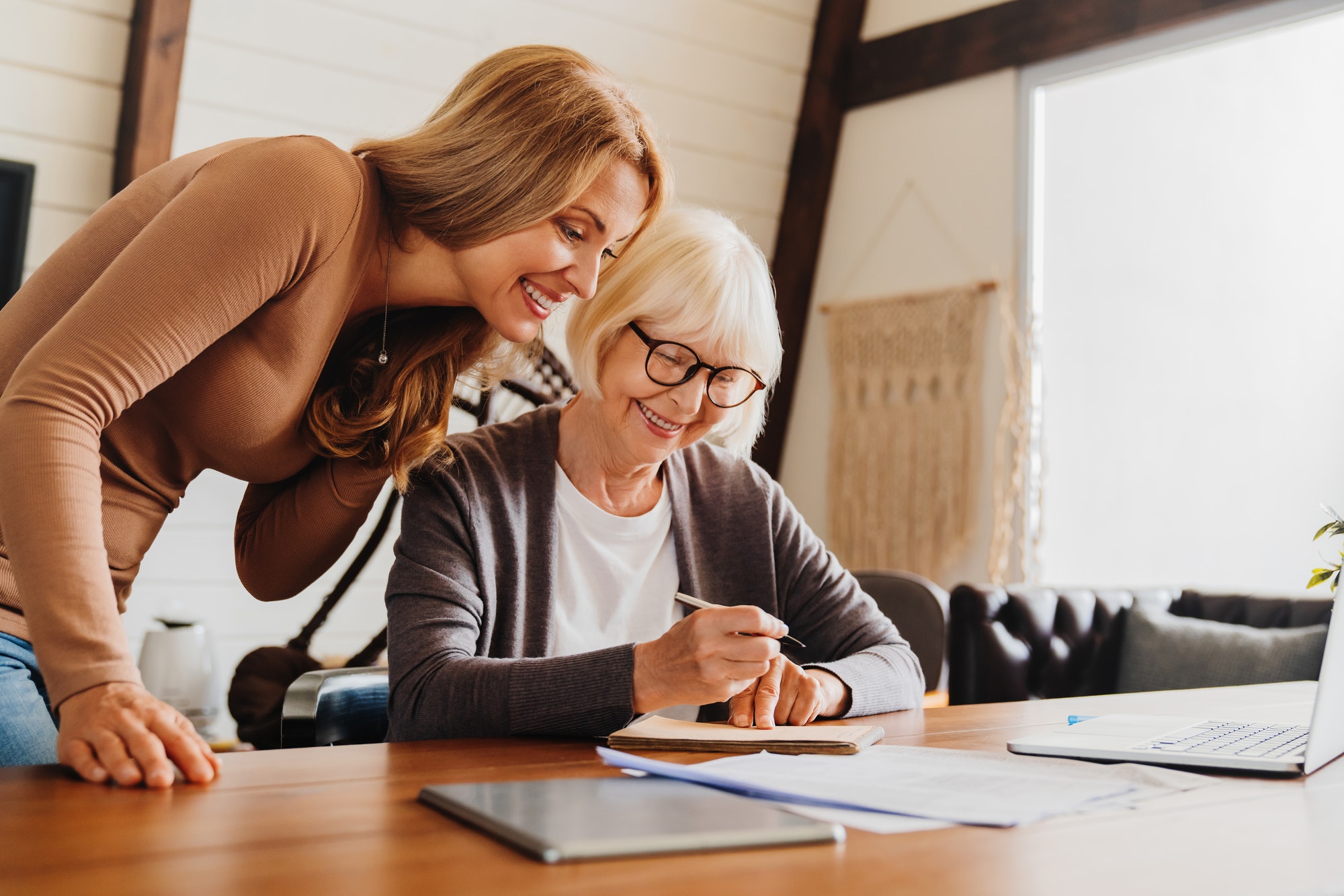 Investment advisor consulting with retired woman at home.