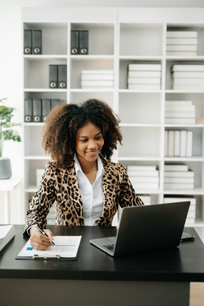 Business woman using tablet and laptop for doing math finance on an office desk, tax, report,